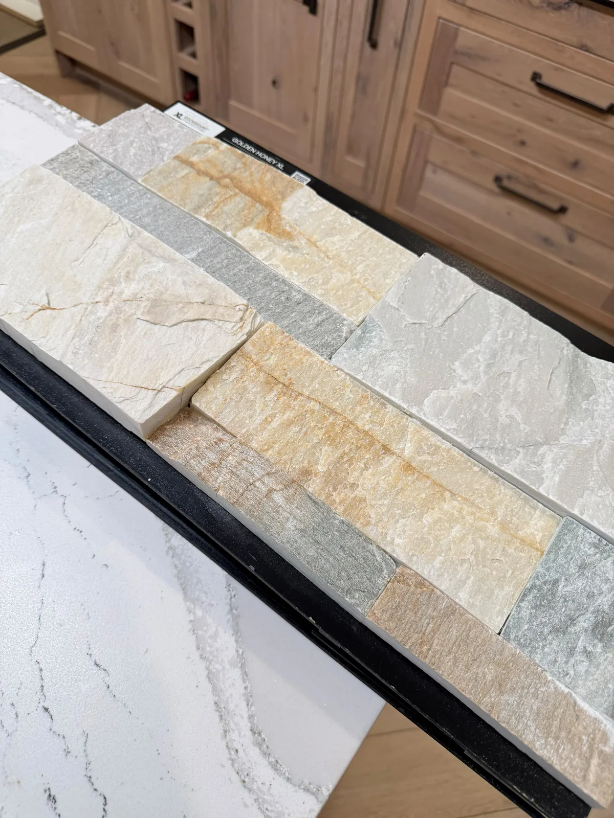 Stacked stone and tile samples being compared for a project